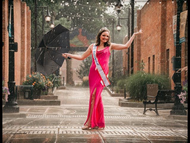 A woman in a pink dress holding an umbrella